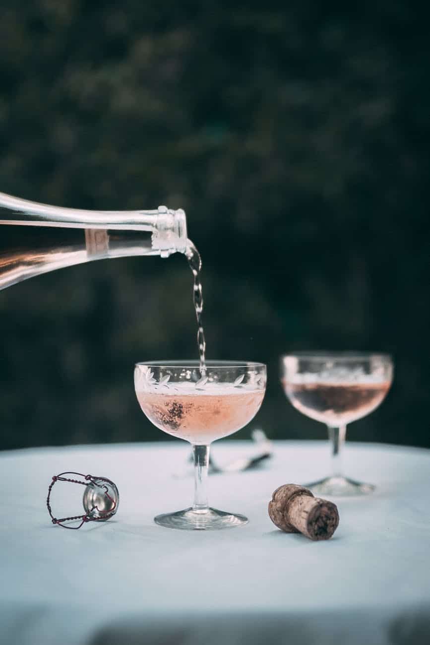 pouring champagne on a glass